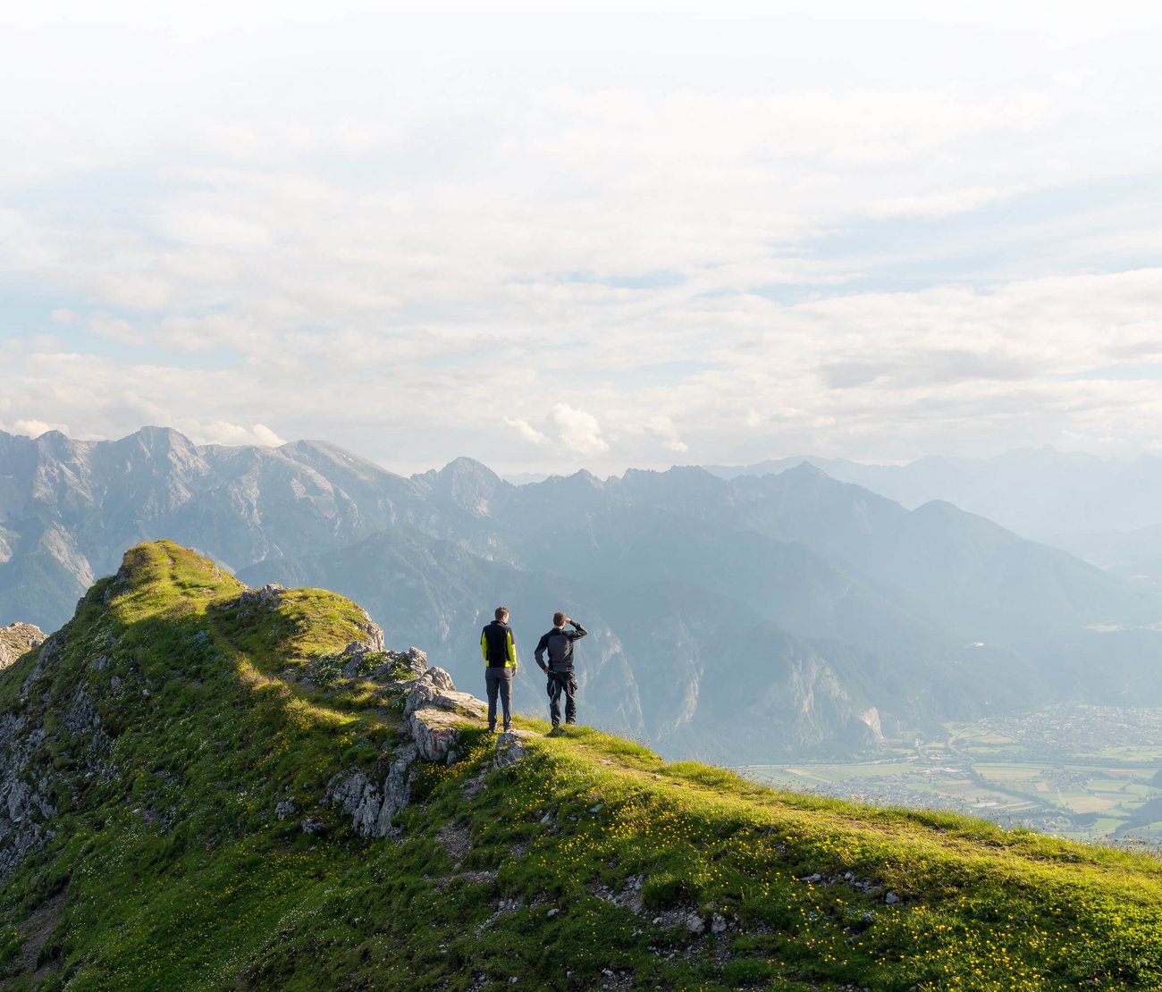 Summer scene. Two men on top of a mountain.