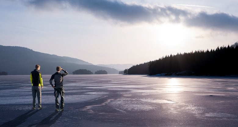 2 men overlooking a lake