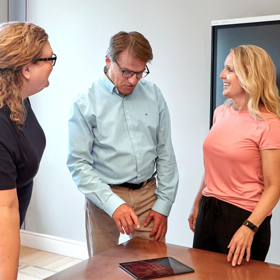 3 people standing taking in office