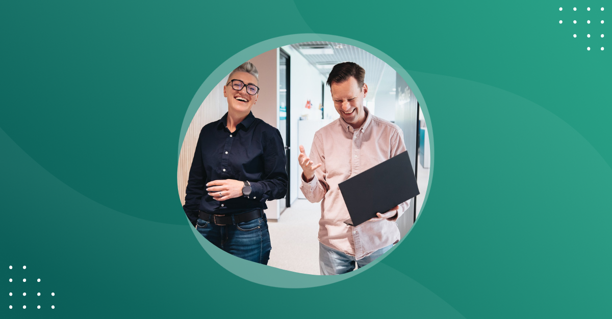 Photo of two colleagues walking and talking in the office