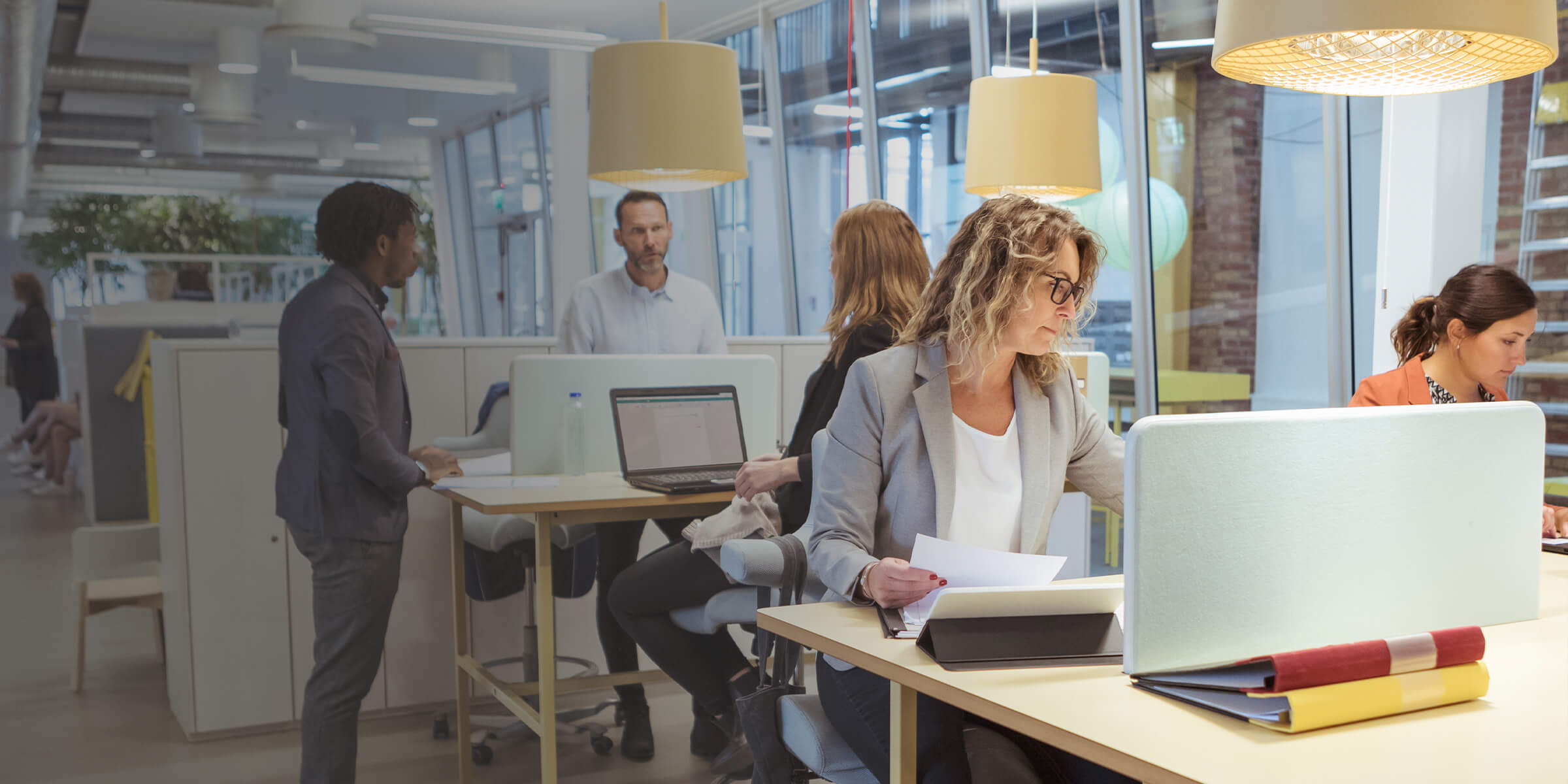 Several people working in a open office