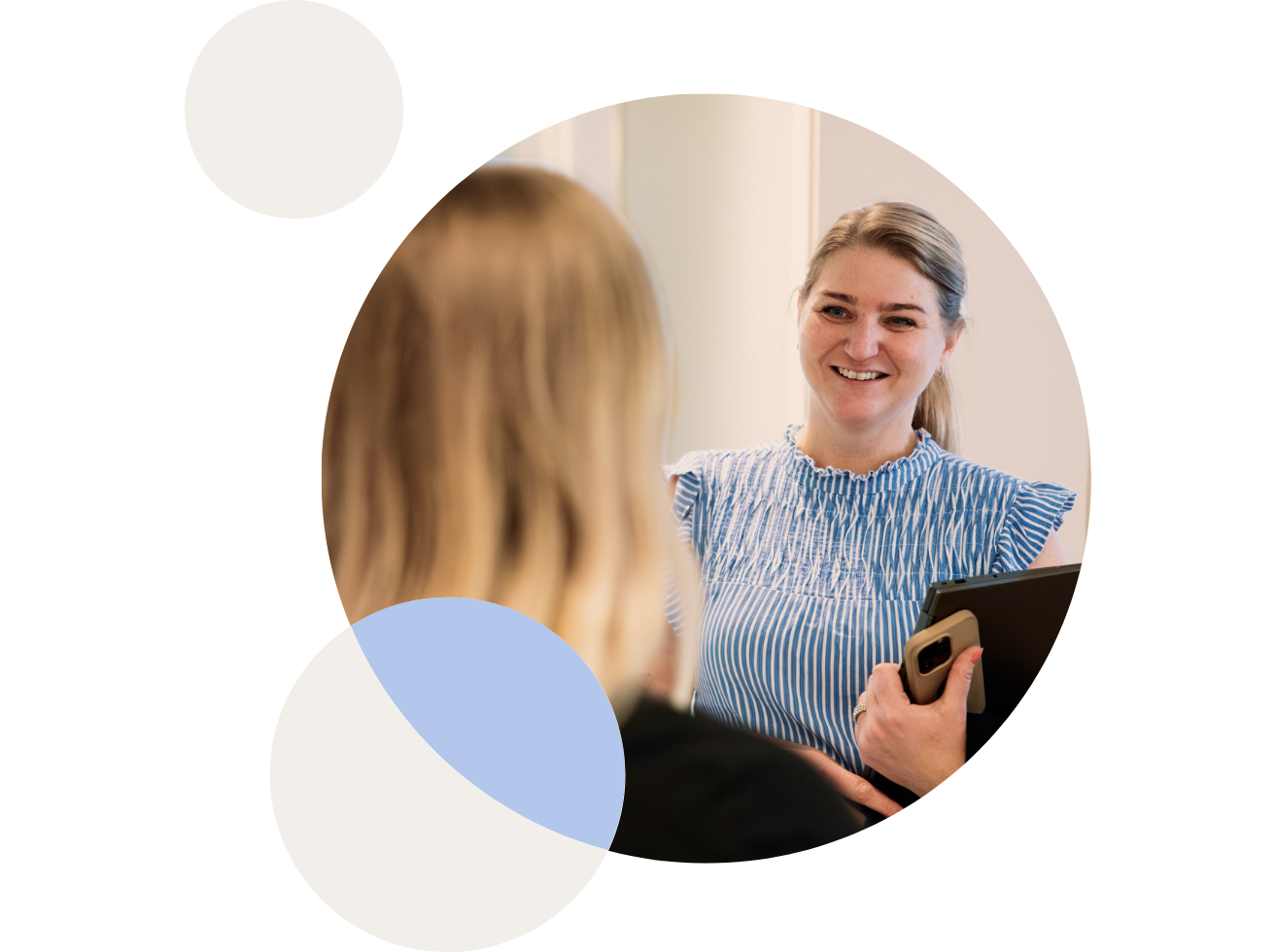 Two woman looking at a floorplan on a Ipad