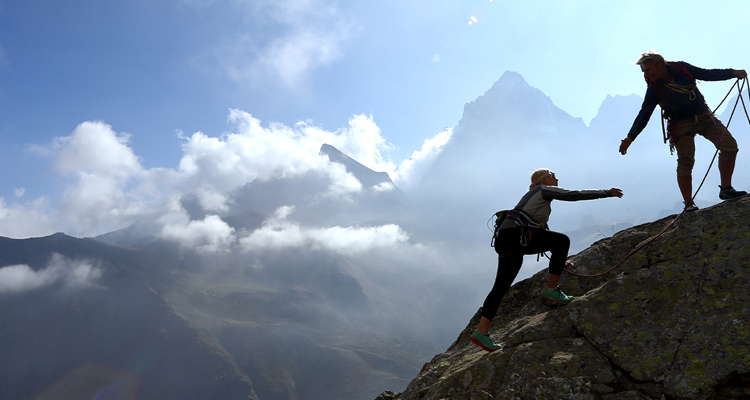 Two people mountain climbing